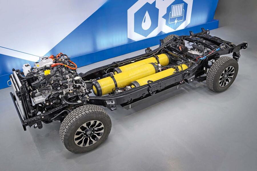 A red lawn mower on freshly cut grass in a garden setting.