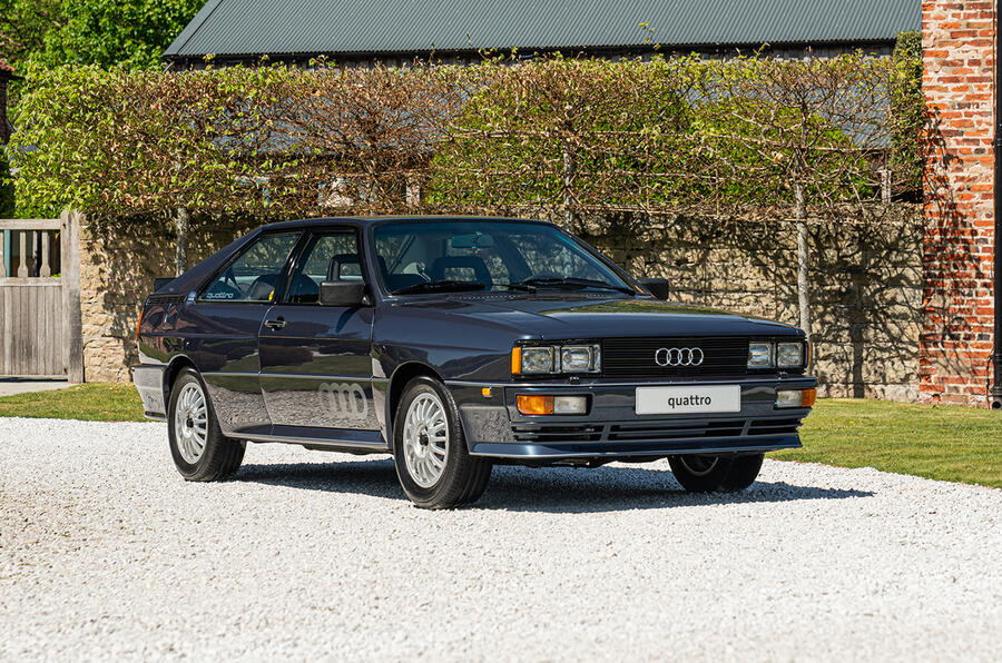 A sleek sports car with a shiny bumper and stylish wheels, showcasing its aerodynamic coupe design.