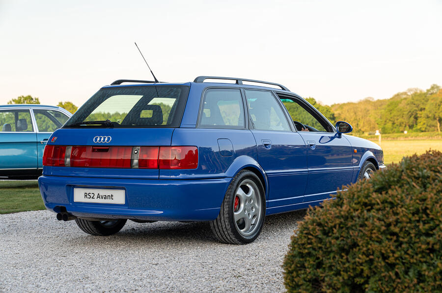 A close-up of a car's front bumper and wheels, showcasing the intricate details of the vehicle as part of modern transportation machinery.