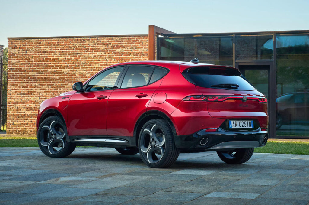A sleek black SUV parked on a city street, showcasing its shiny exterior and modern design.