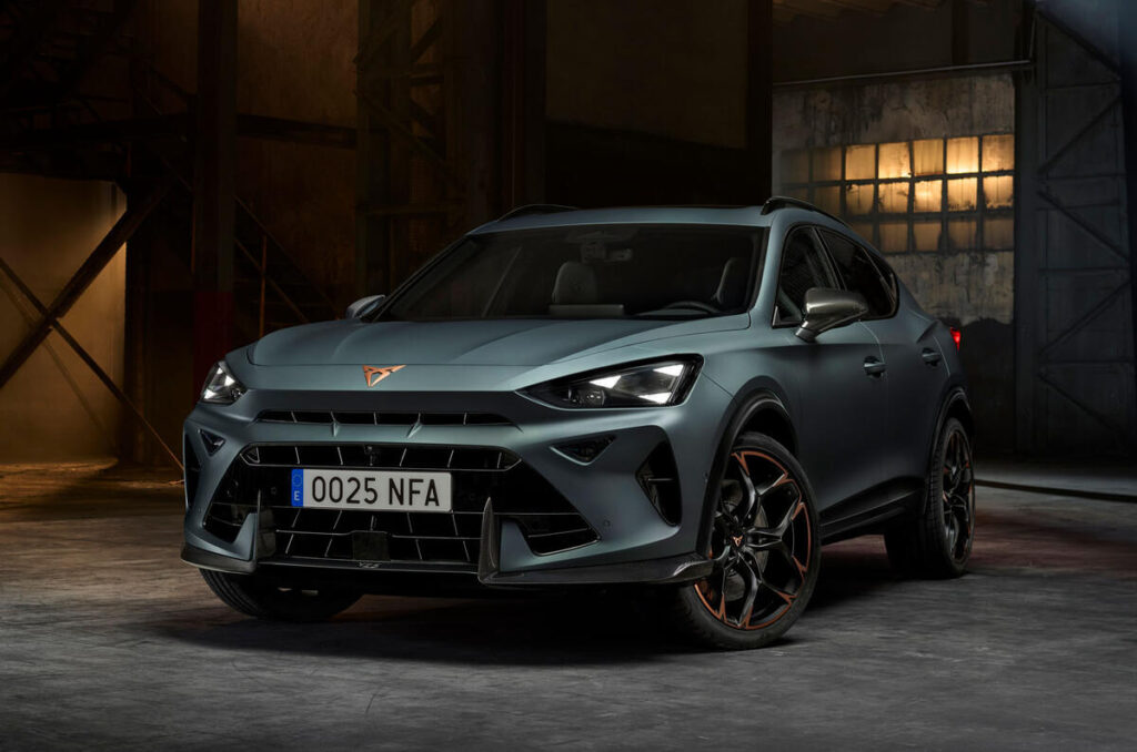 A sleek red sports car parked in an urban setting, showcasing its aerodynamic design and shiny wheels.