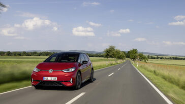 A modern hatchback car parked by the roadside, featuring sleek design and shiny wheels.
