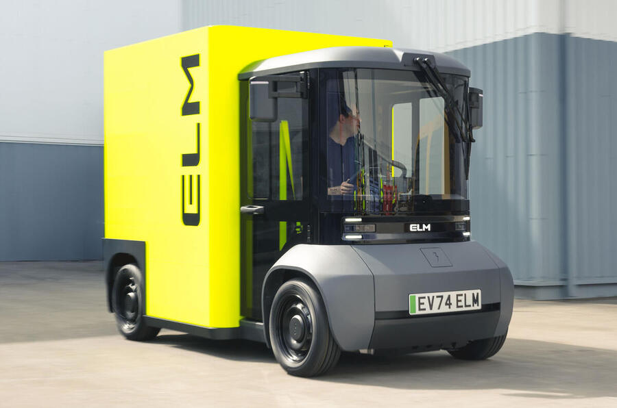 A forklift transporting materials next to a large truck in an industrial setting.