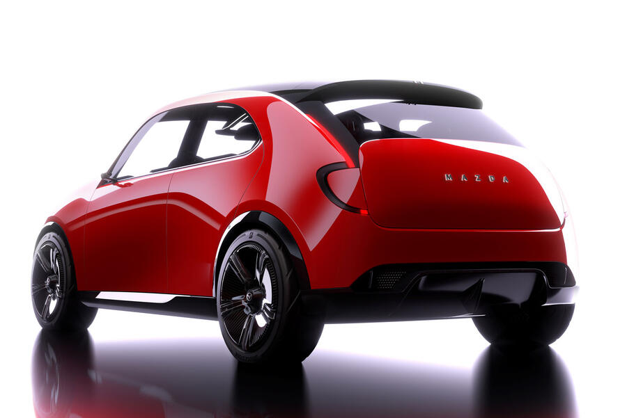 A black SUV parked on a city street, showcasing its sleek design and modern wheels.