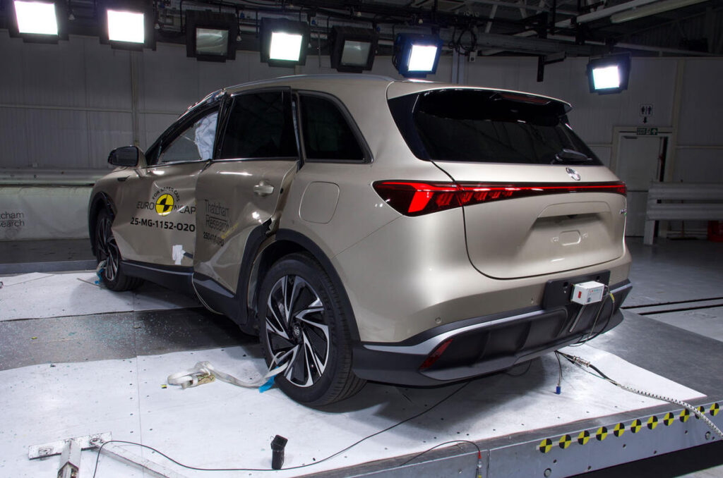 A sleek, modern car parked on a city street, showcasing its shiny wheels and streamlined design.