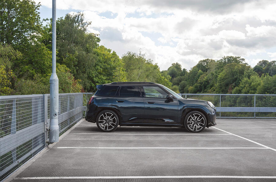 A modern SUV parked on a city street, showcasing its sleek design and shiny wheels.