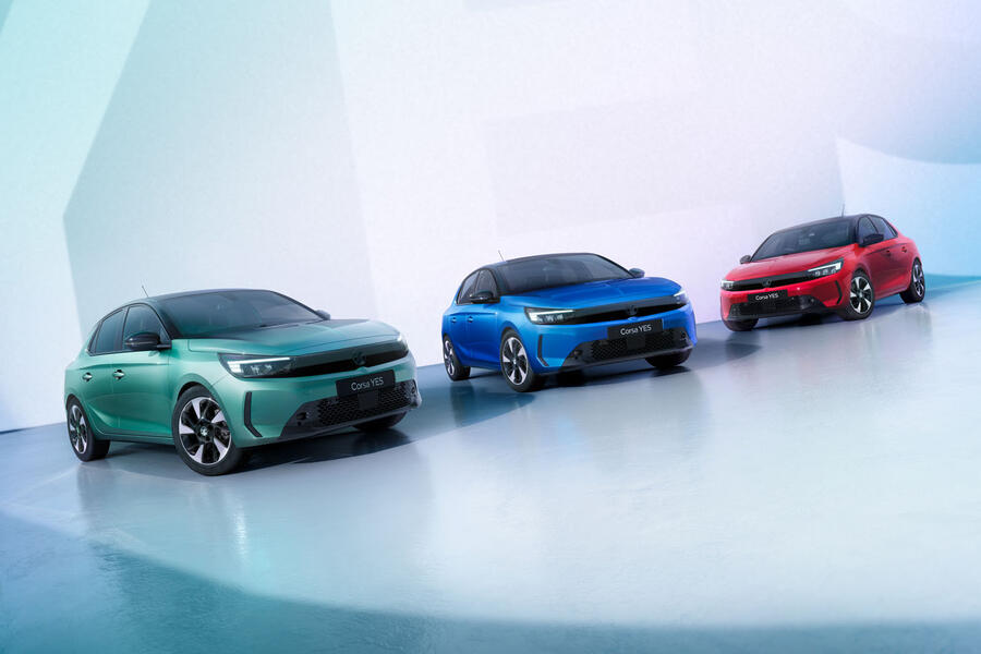 A sleek red sports car parked on a sunny street, showcasing its aerodynamic design and shiny wheels.